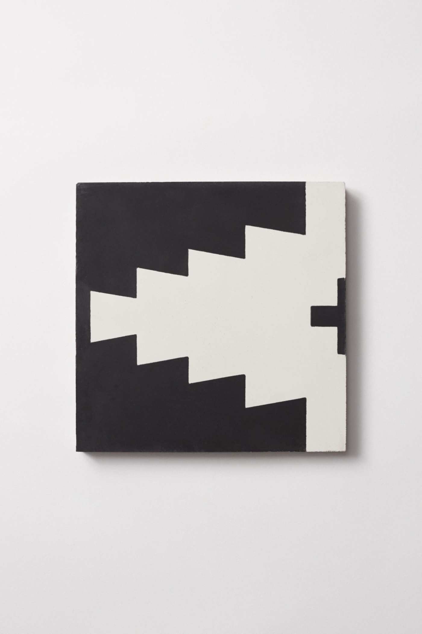 a black and white tile on a white surface.