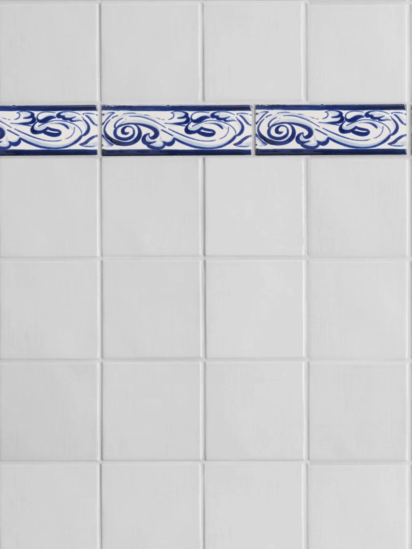 a blue and white tiled bathroom with a decorative border.