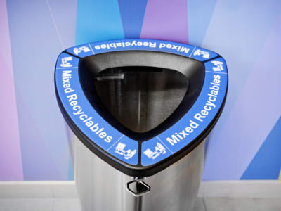 single stream mixed recyclables collection bin made from stainless steel with a lockable steel lid at a university campus