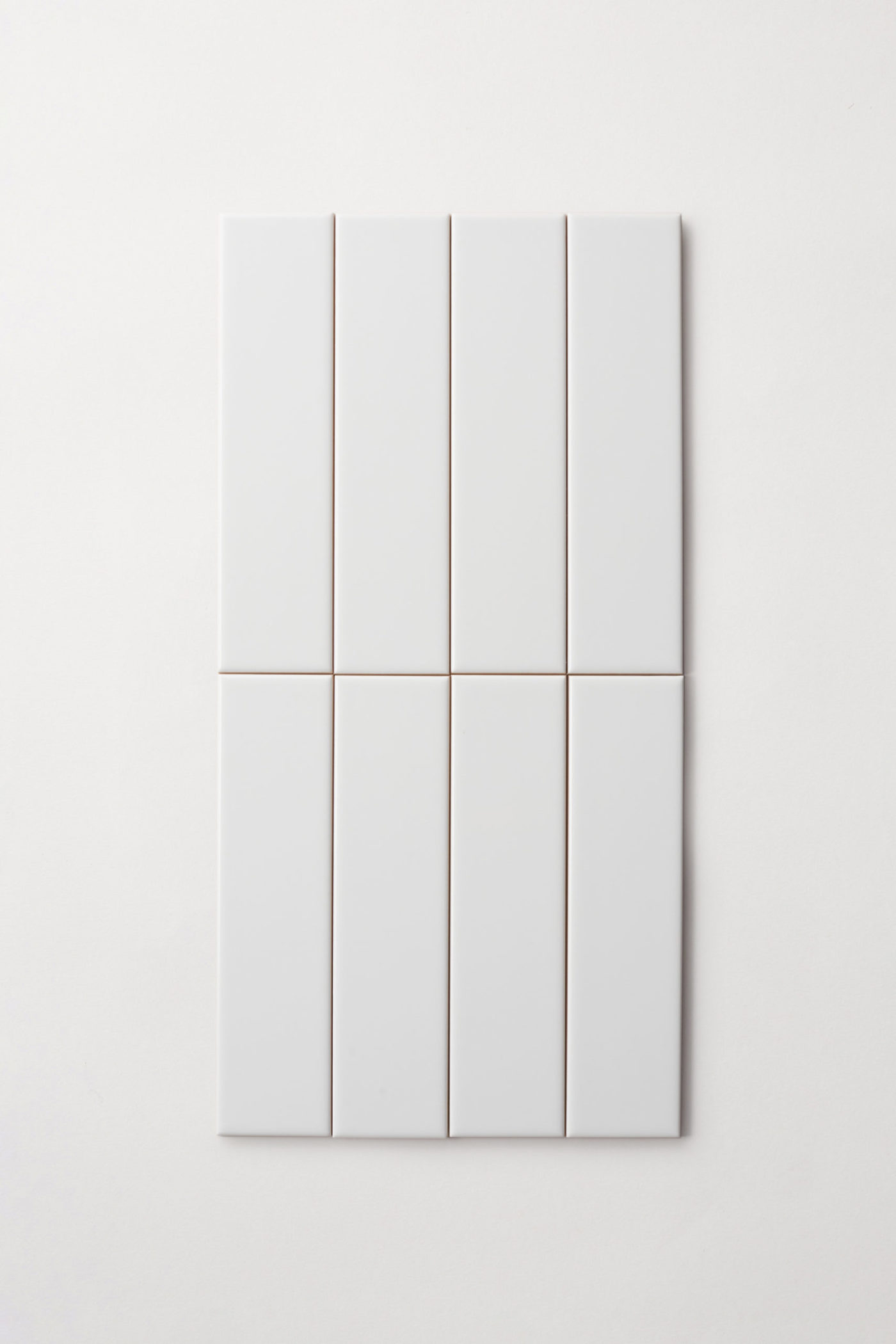 a set of white rectangle tiles on a white surface.