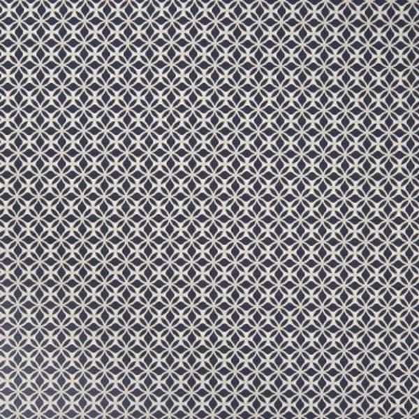 White interlocking circular-lattice pattern on navy fabric; repeating tessellated motif covering the entire surface; appears as flat wallpaper or upholstery in even, diffuse interior lighting.