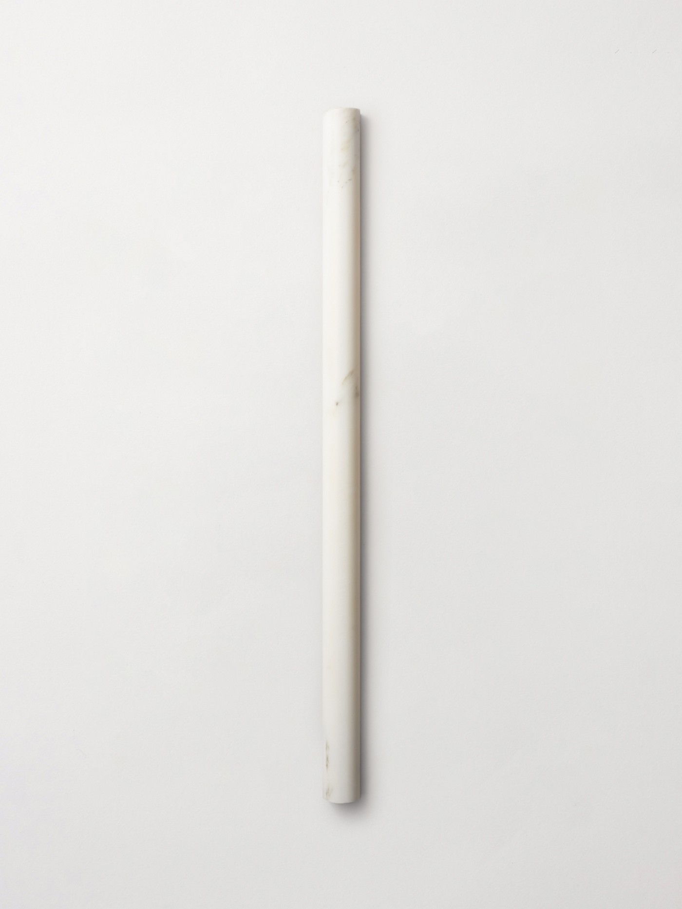A single  long linear, curved convex stone tile in color Calcatta Gold, from clÃ©âs Lapidary collection featuring 3d sculpted (fluted and rounded) shapes.