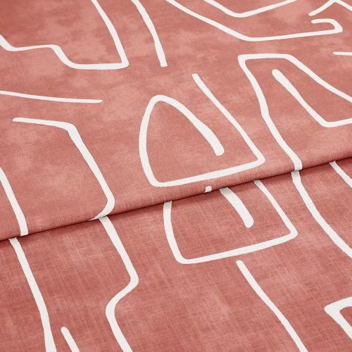 Folded patterned fabric: a rose‑terracotta curtain-like textile with white abstract line motifs, folded once across the frame. Close-up studio view emphasizing soft woven texture and matte finish.
