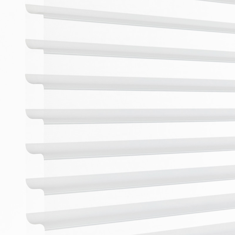 White horizontal sheer zebra blinds mounted over a window, alternating opaque and translucent bands; partially closed, filtering bright daylight into a minimal, evenly lit interior.