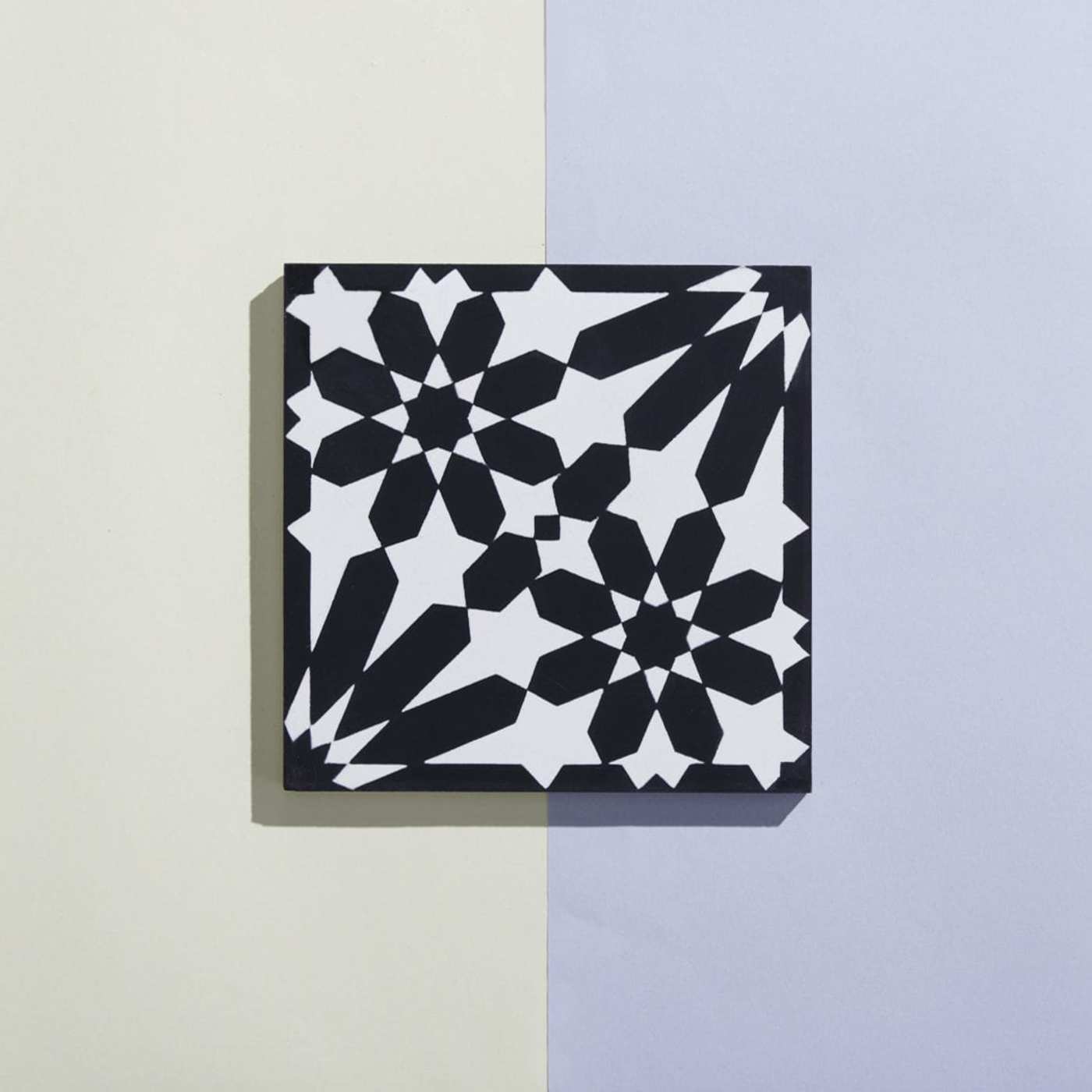 a black and white tile on a blue and white background.