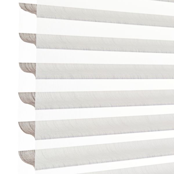 Sheer zebra roller blinds with alternating opaque and translucent horizontal bands, lowered to filter and diffuse bright daylight, shown close-up against a plain white background in soft light.