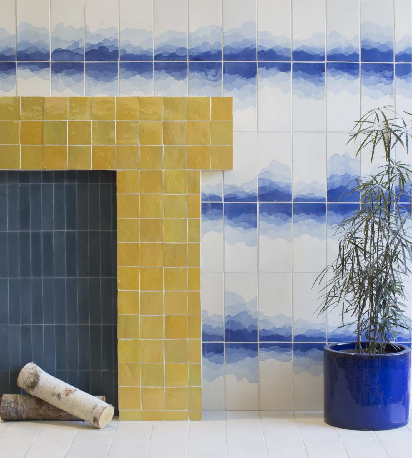 a blue and yellow tiled fireplace with a potted plant.