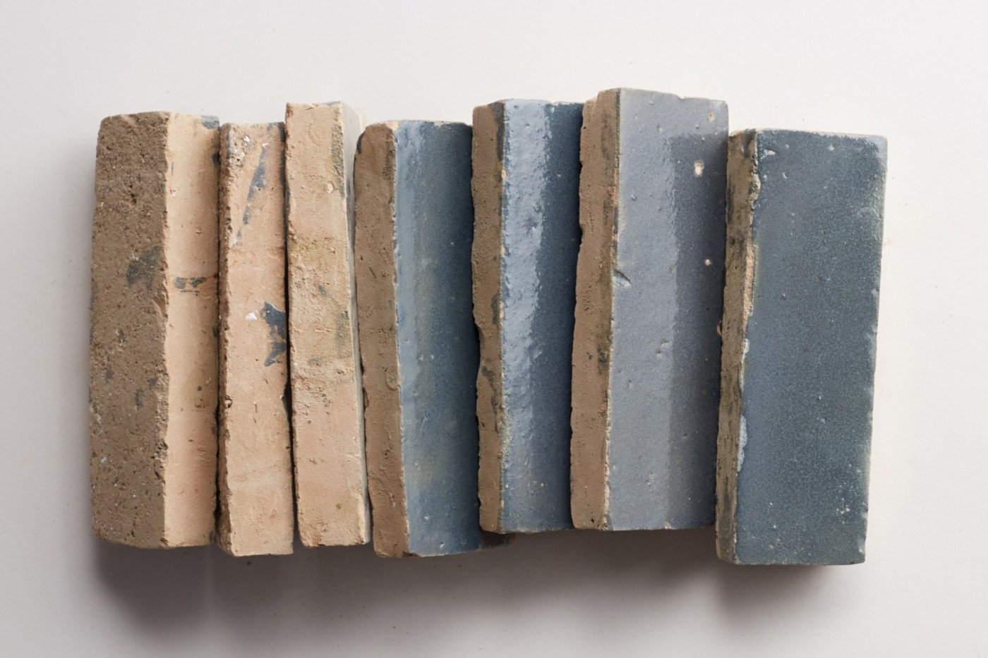 a stack of blue tiles on a white surface.