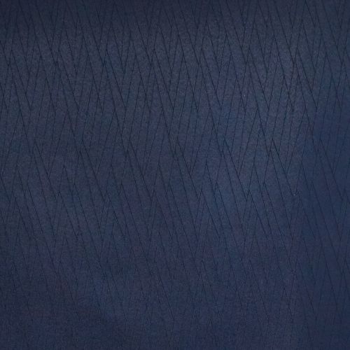 Navy-blue quilted fabric panel with narrow diagonal stitched diamonds, the quilting forming overlapping chevrons; close-up, evenly lit flat surface suggesting upholstery or textured wall covering.