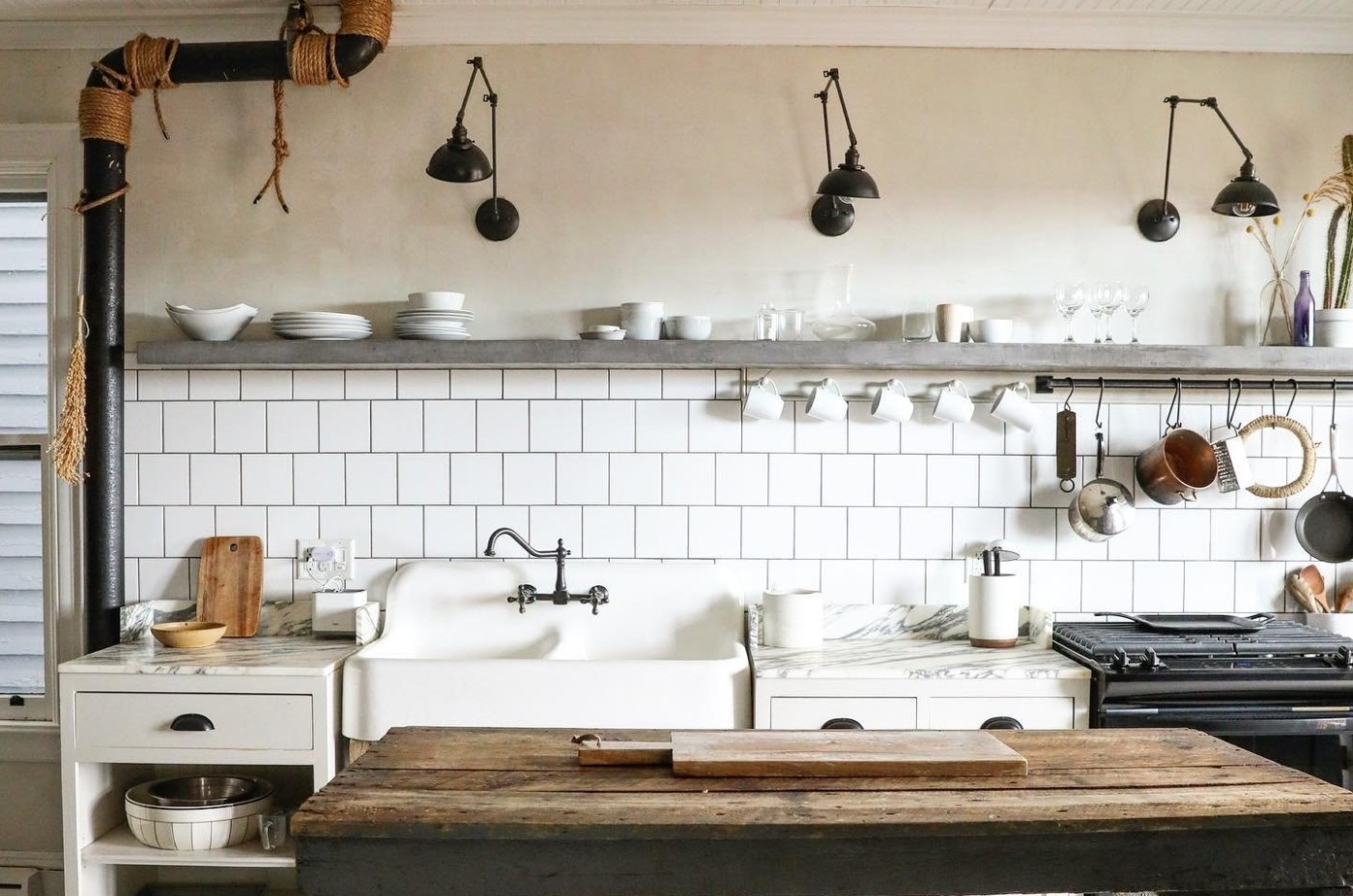 a kitchen with a wooden table and a sink.