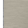 Beige honeycomb cellular window blind with pleated horizontal ribs and exposed left-edge cells â€” fully lowered and closed, blocking view; close-up fills frame in neutral, even lighting.