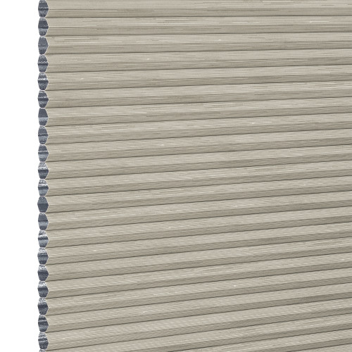 Beige honeycomb cellular window blind with pleated horizontal ribs and exposed left-edge cells â€” fully lowered and closed, blocking view; close-up fills frame in neutral, even lighting.