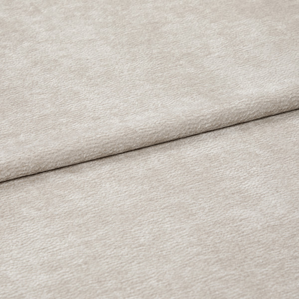 Beige textured fabric, folded with a horizontal overlap; soft, slightly napped surface; close-up, evenly lit view of neutral upholstery or drapery textile.