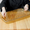 Full-size Super Pan® high-temperature plastic false bottom in amber