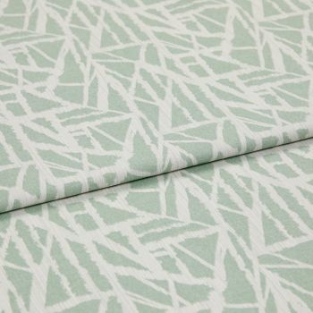 Folded pale green-and-white woven fabric with angular, leaf-like geometric pattern and subtle ribbed texture â€” overlapped across the frame â€” close-up on a flat, softly lit studio background.