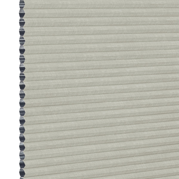 A closed light-gray cellular (honeycomb) window shade, hexagonal dark-gray cell edges visible along the left; filtering light while covering the opening; close-up view with neutral, even lighting.