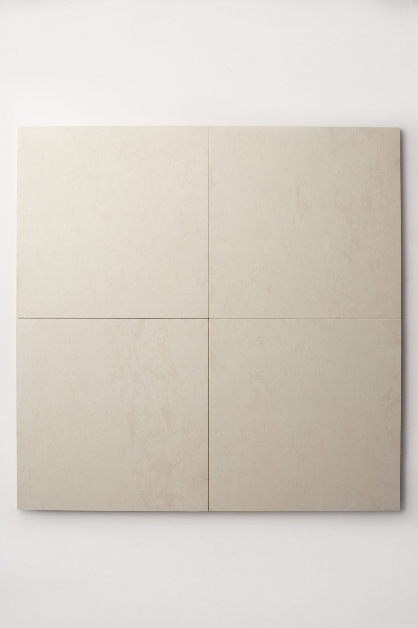 Four square off white colored limestone tiles form a large square centered on a white background. Grand Place collection in Tabor, from clÃ© Tile.