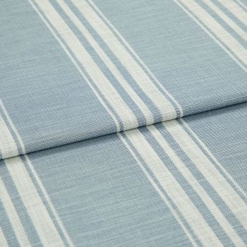 Blue-and-white striped woven fabric (curtain sample) folded into layers; vertical white stripe bands on pale blue ground, textured weave visible, close-up on flat surface under soft, even lighting.