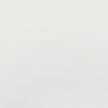 Blank off-white wall with subtle mottled texture (object), occupying the frame and uniformly lit (action), suggesting a neutral interior surface or sheet of paper under soft, diffuse lighting (context).