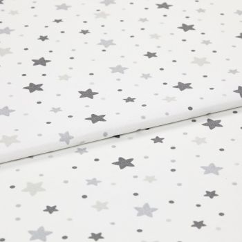 White cotton fabric patterned with scattered grey stars and small dots, folded and layered on itself; photographed as an evenly lit close-up, resembling a nursery textile sample.
