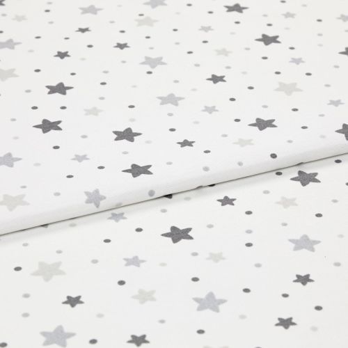 White cotton fabric patterned with scattered grey stars and small dots, folded and layered on itself; photographed as an evenly lit close-up, resembling a nursery textile sample.