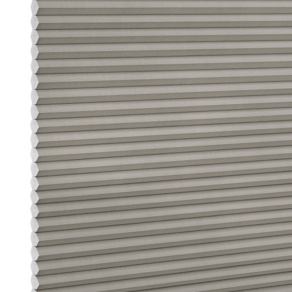 Grey honeycomb (cellular) blind, fully lowered with visible hexagonal cells along the left edge, blocking light; close-up product shot with even lighting and white background.