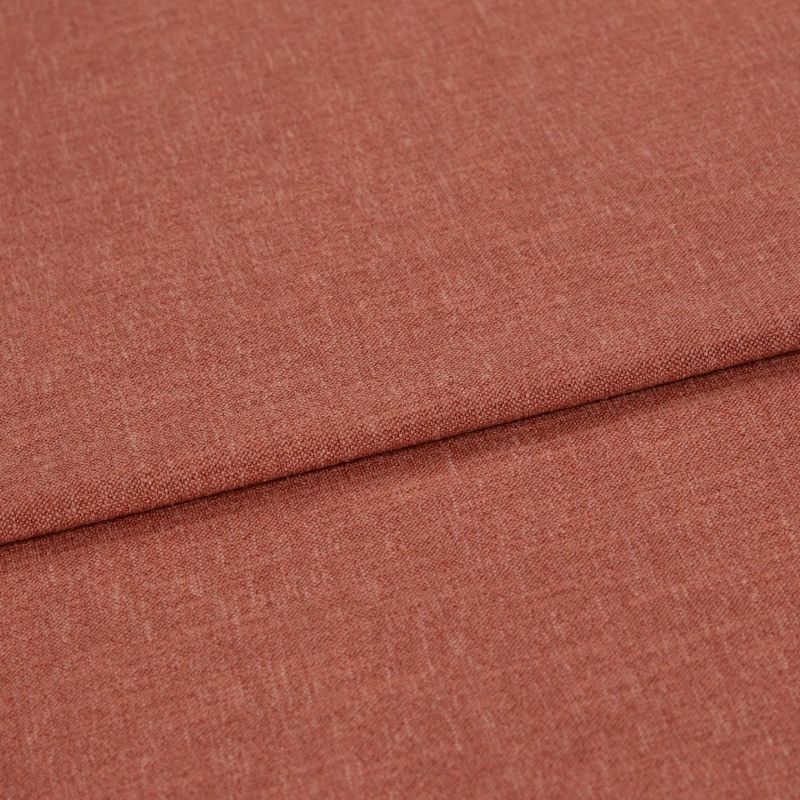 Woven terracotta textile, folded with an overlapping crease, displayed in a well-lit close-up emphasizing its fine, slightly heathered weave and flat, smooth surface.