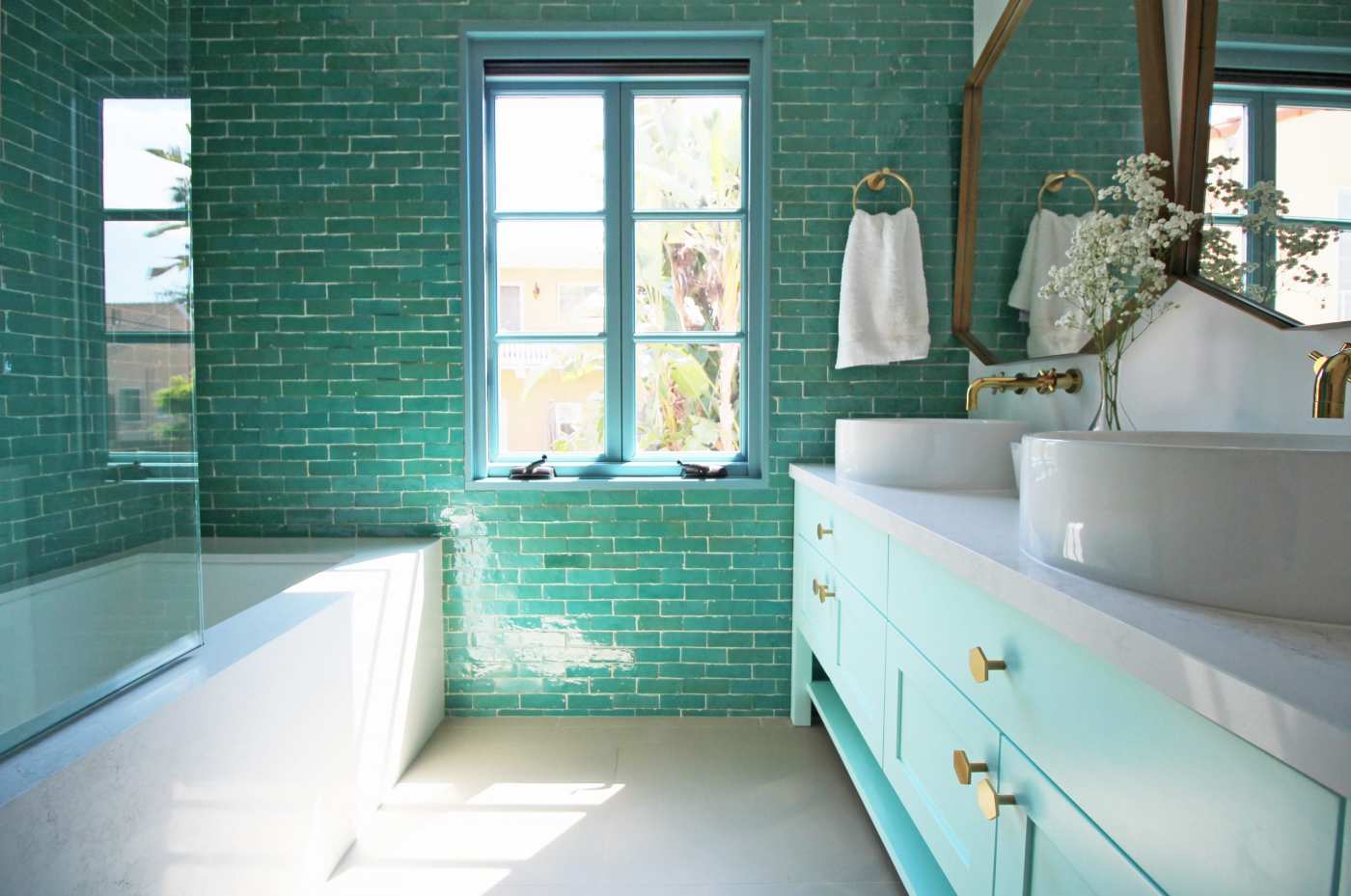 a bathroom with turquoise tile.