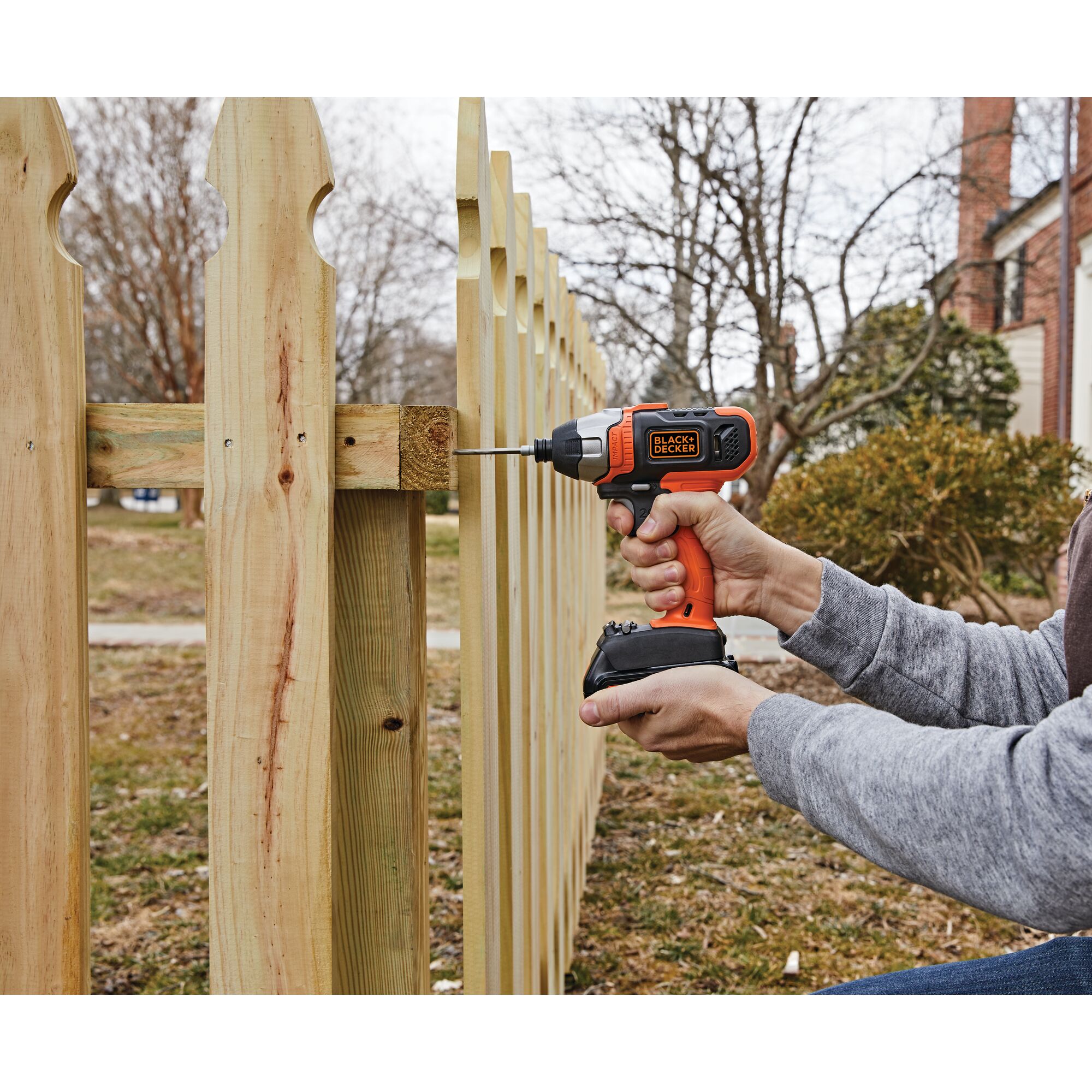 Cordless Impact Driver being used for fixing wooden fence.