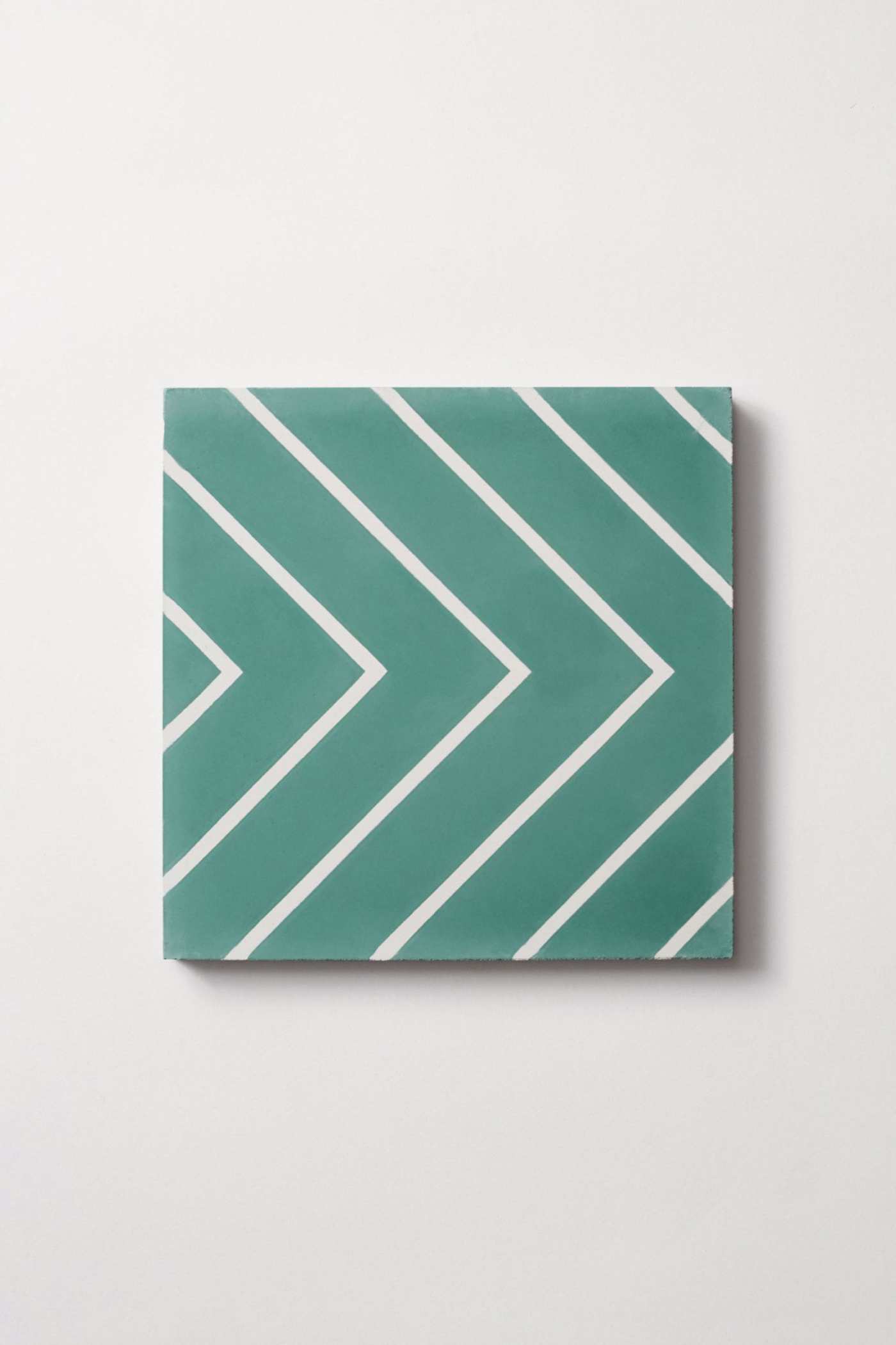 a green and white chevron pattern on a white surface.