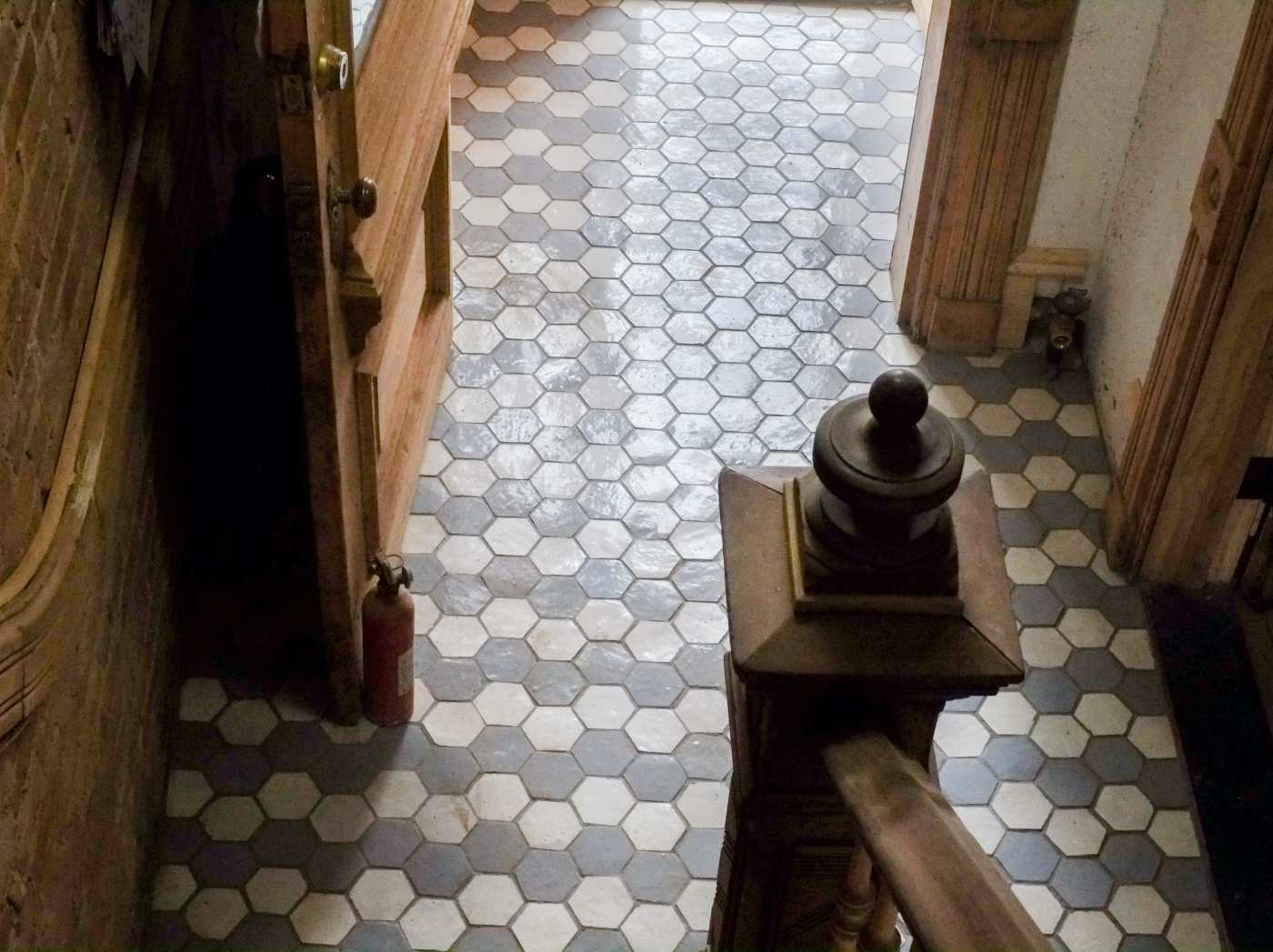 a hallway with a doorway and a tiled floor.