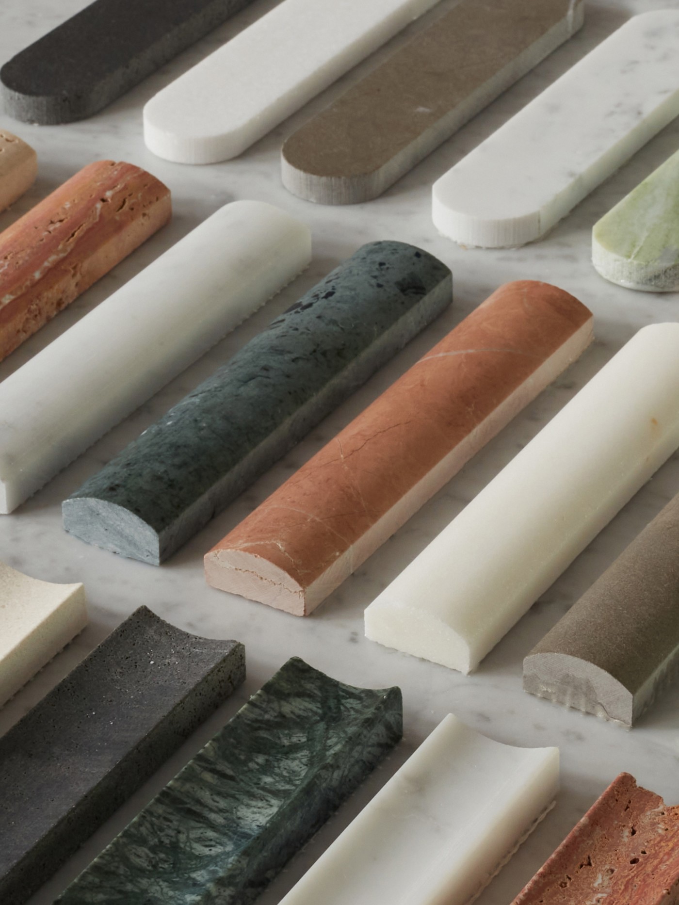 a variety of different colored marbles are laid out on a table.