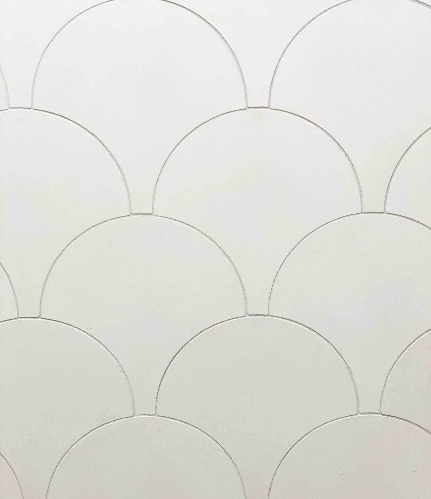 a surface with white scallop-shaped tiles.