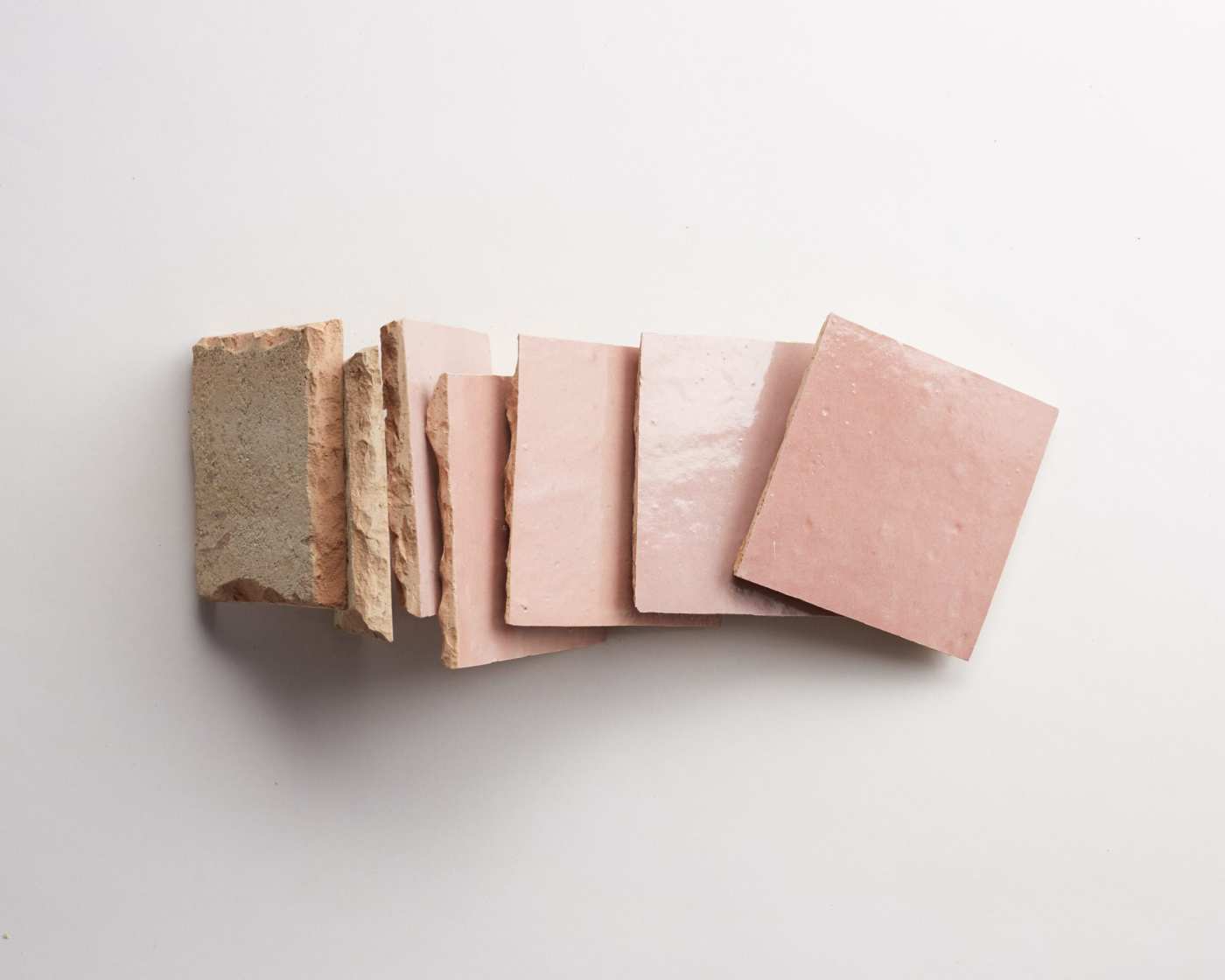 a stack of pink tiles on a white background.