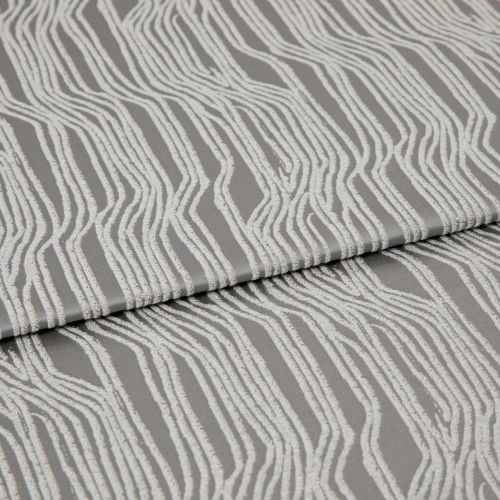 Textured grey upholstery fabric with raised white irregular vertical stripes, folded horizontally across the frame; fabric lies flat in a studio close-up with soft, diffuse lighting highlighting its sheen.