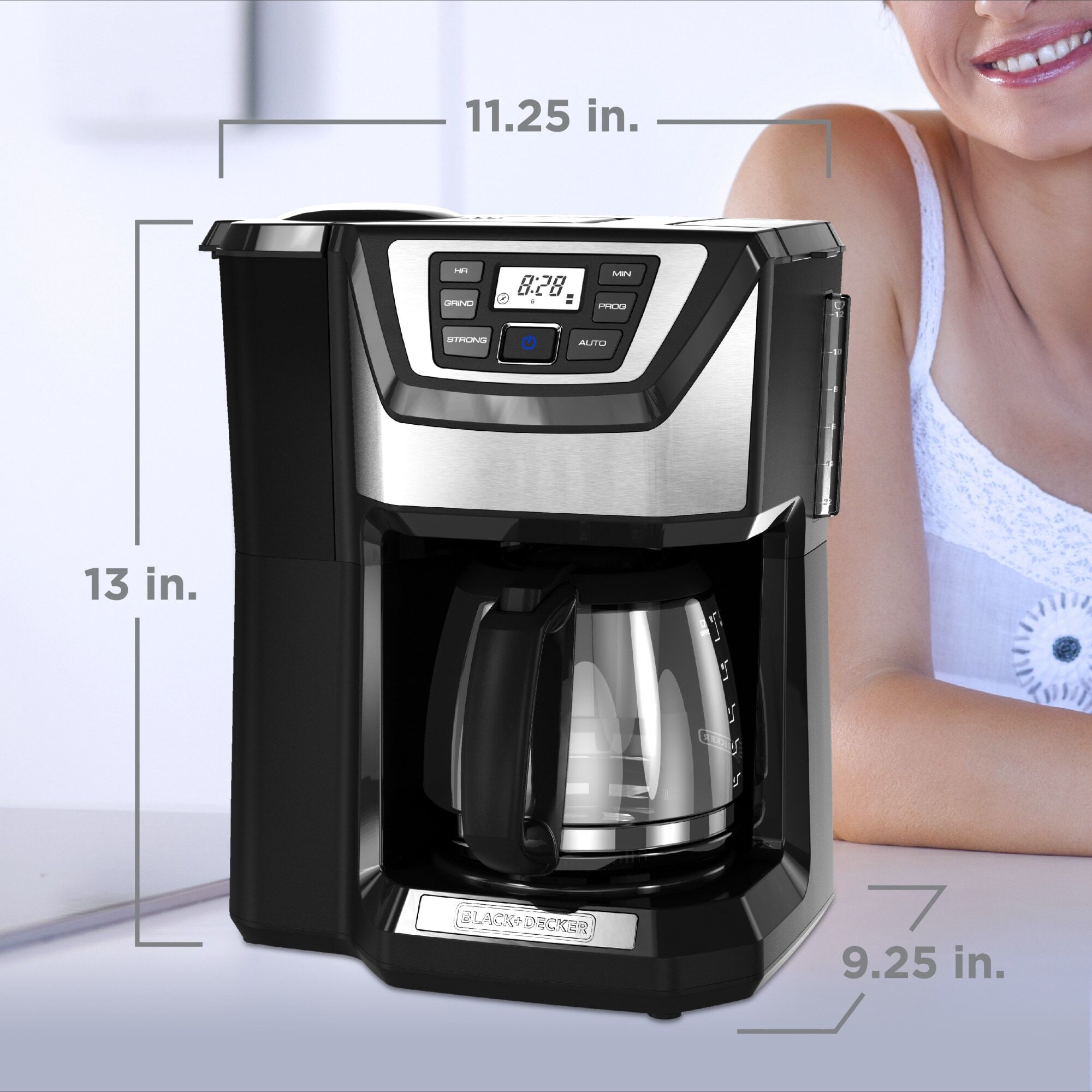 Woman smiling next to coffee maker which is on a counter