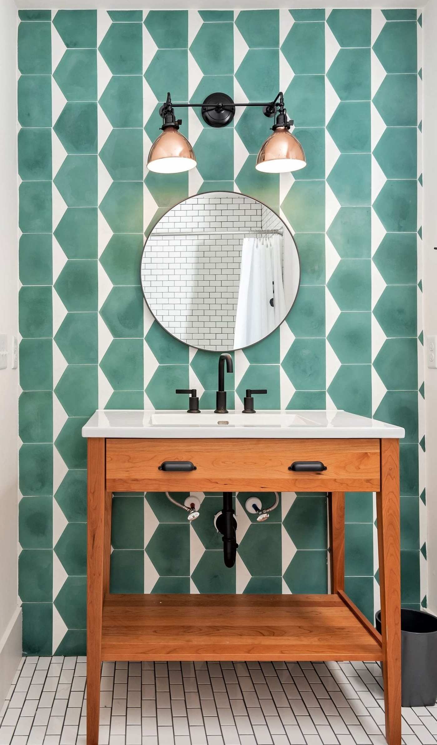 a bathroom with a green and white tiled wall.