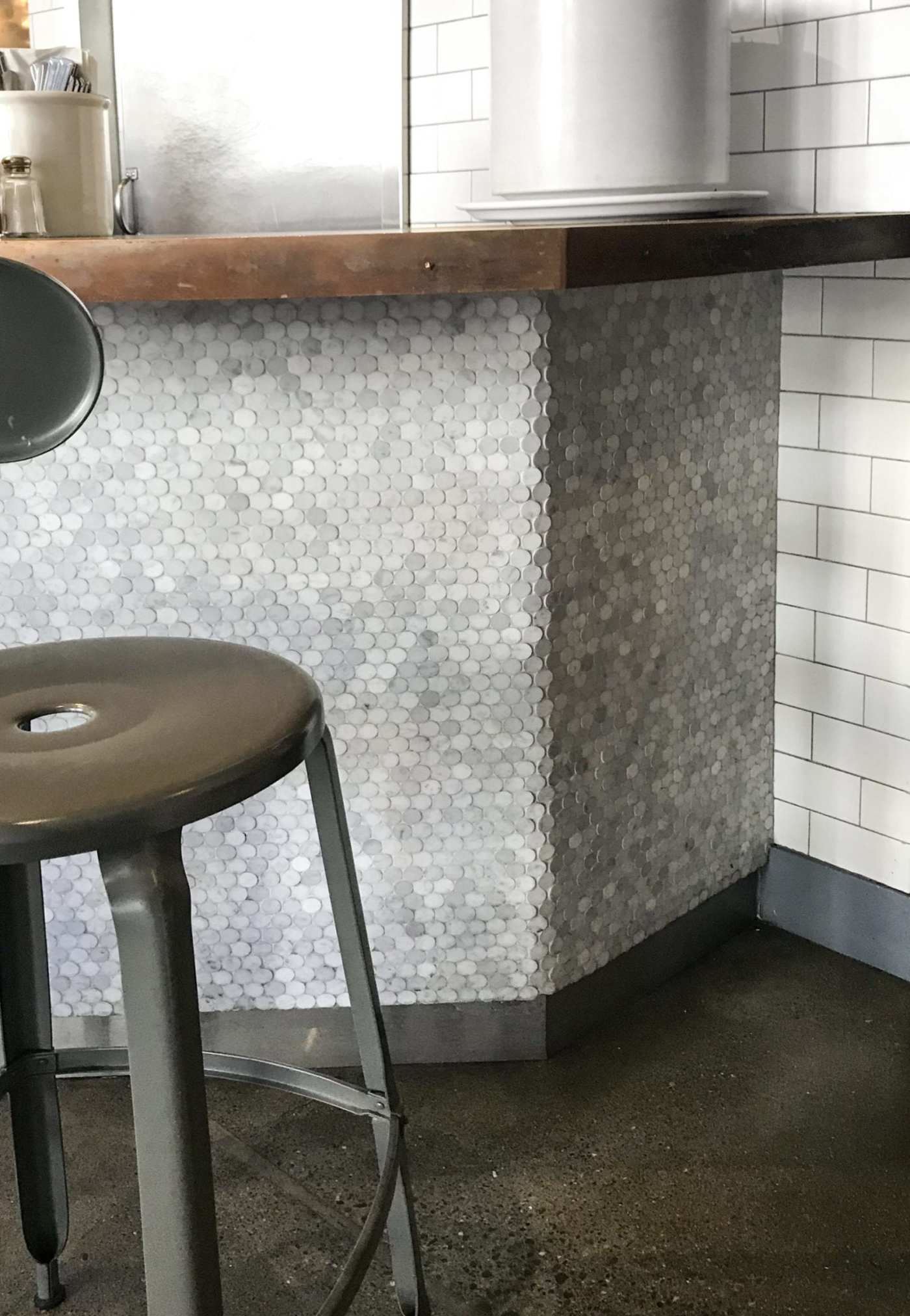 a stool sits in front of a kitchen counter.