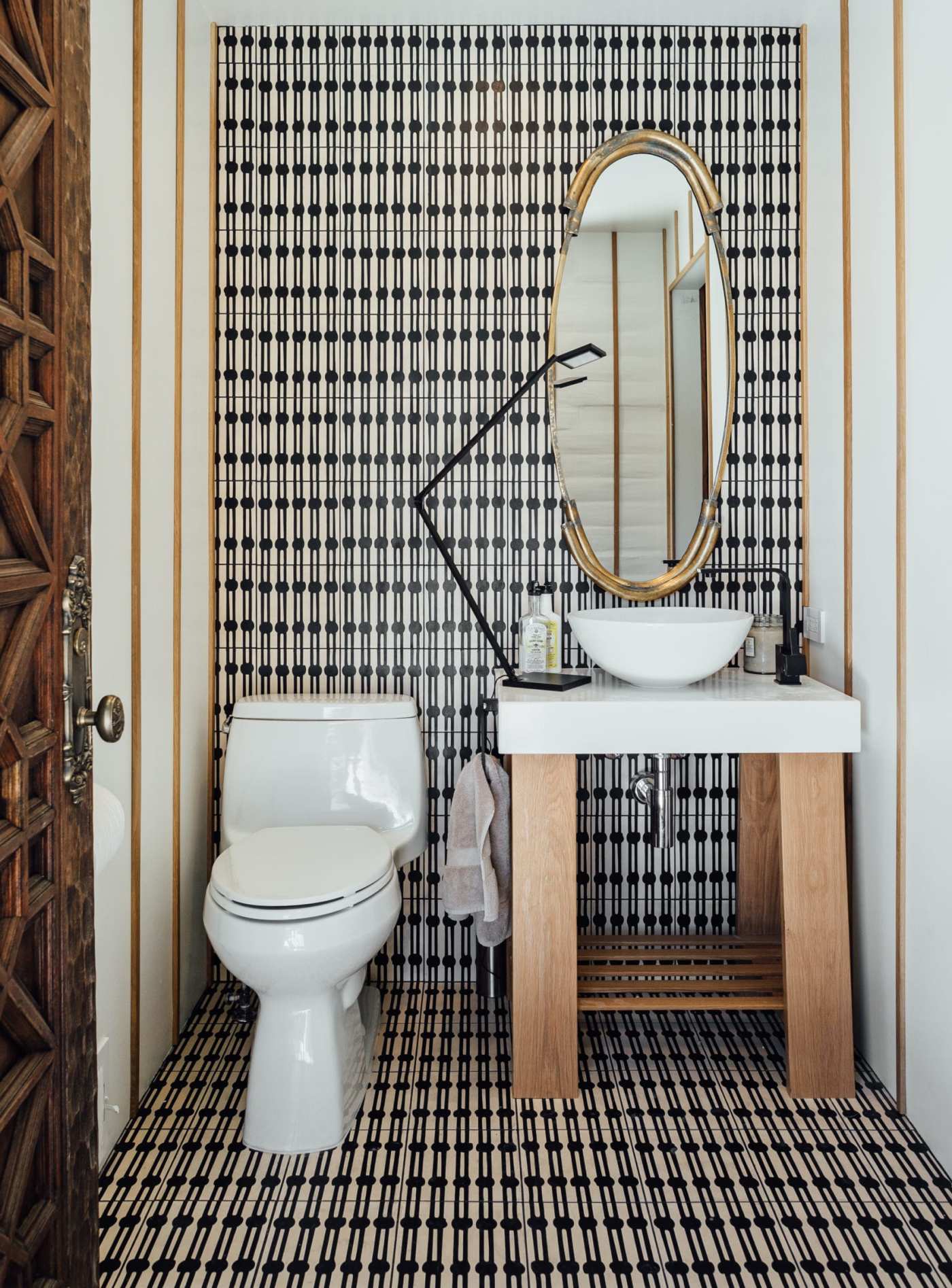 a bathroom with a black and white checkered floor.