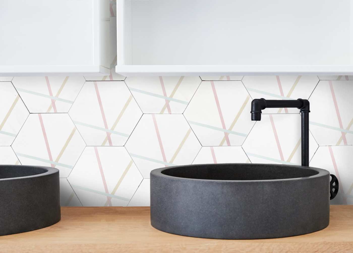 two sink and a white hexagonal tiled backsplash.