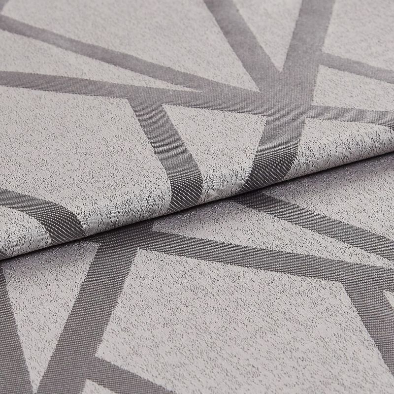 Textured light-grey fabric with dark-grey intersecting geometric bands (raised weave), folded once to reveal the edge; close-up studio-lit view highlighting weave, pattern and subtle sheen on a neutral surface.