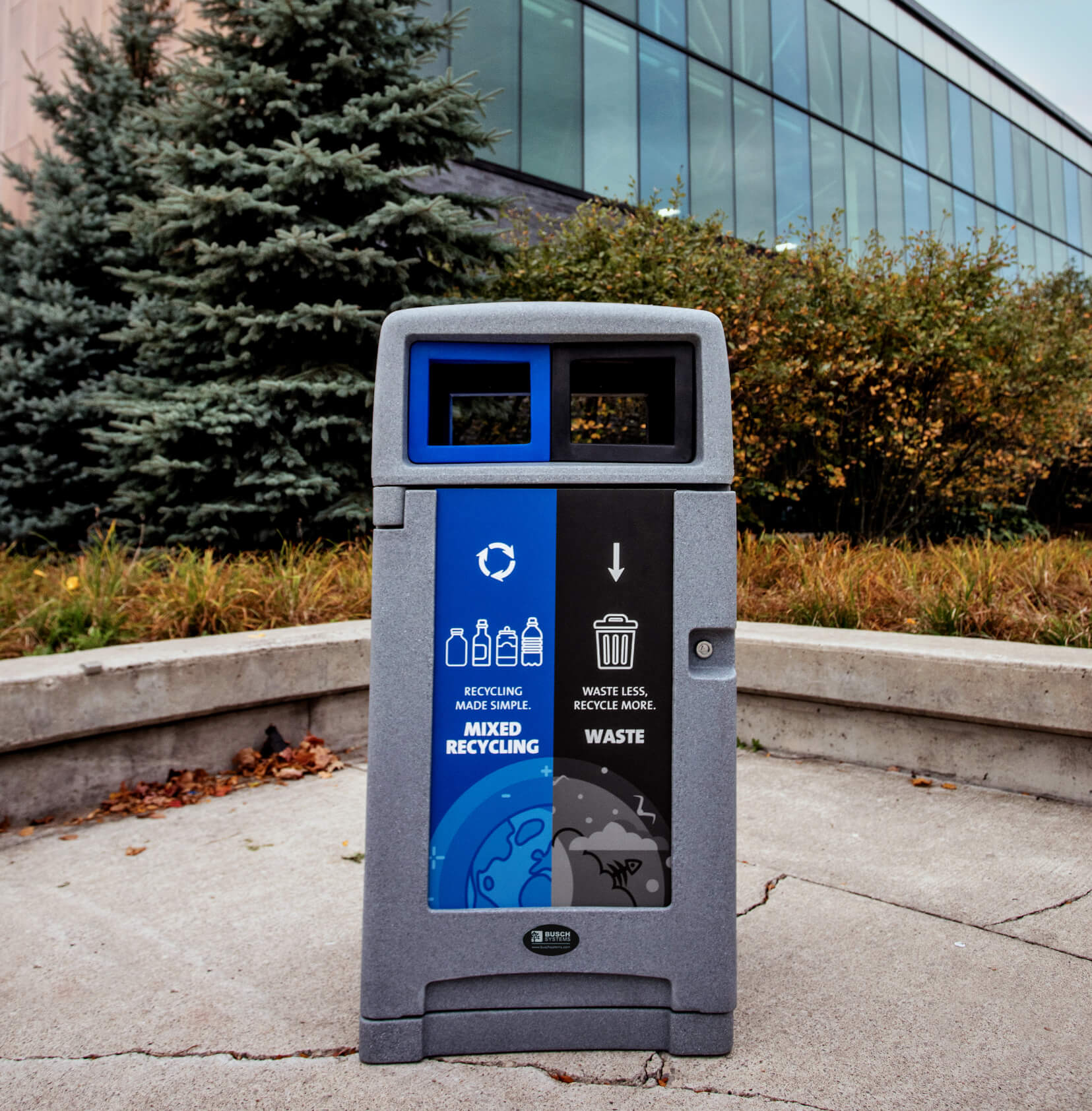 double mixed recycling and waste bin with outdoor canopy lid and colored openings outside at a recreation facility