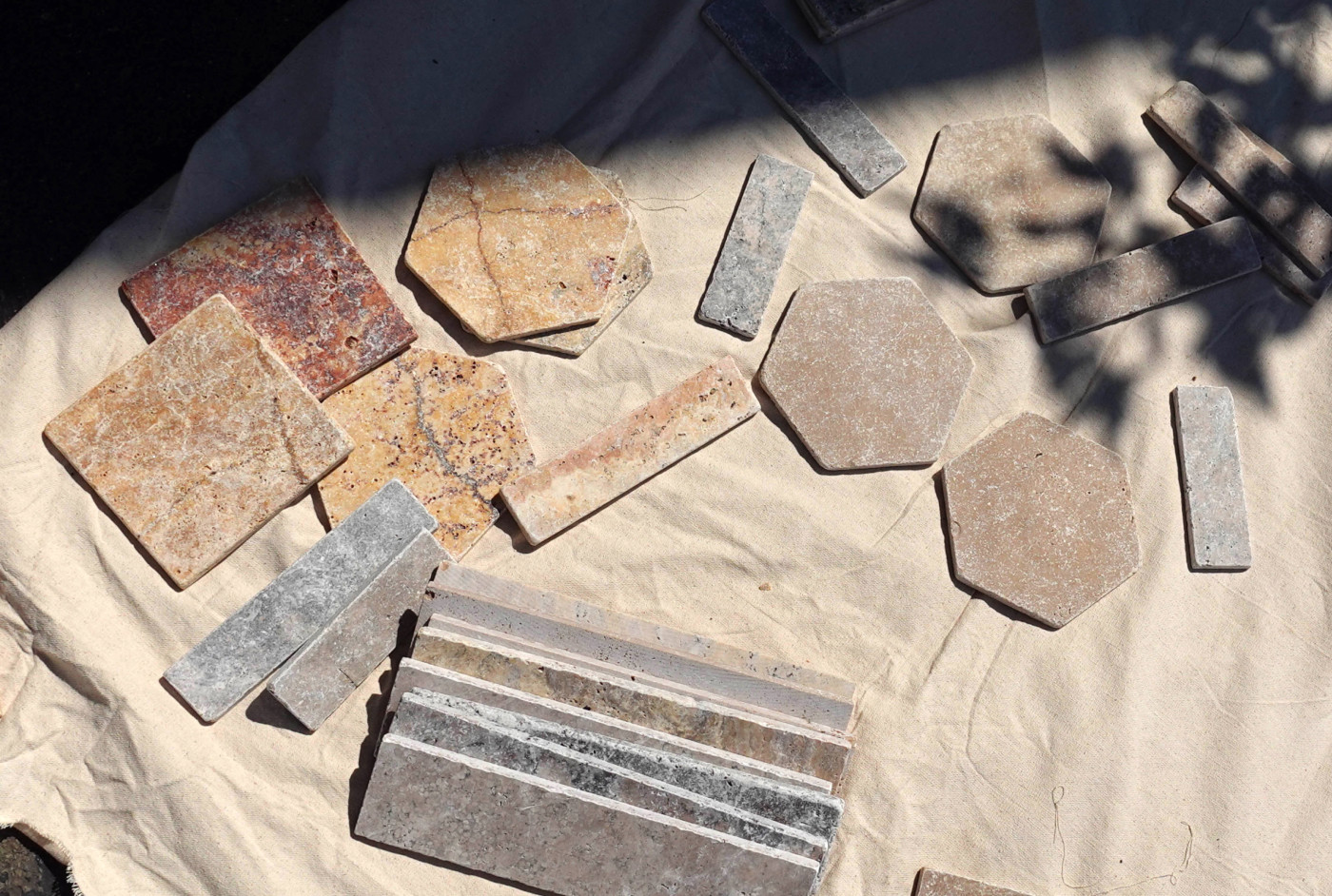 a group of tiles laid out on a piece of cloth.