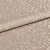 Beige jacquard fabric with glossy, raised crescent pattern; folded once across the frame, overlapping edges; close-up studio view with soft, diffuse lighting emphasizing the textured sheen.