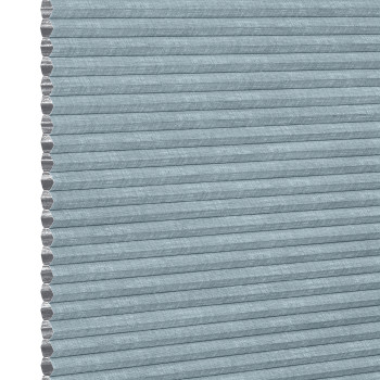 Light-blue textured cellular (honeycomb) pleated shade, tightly closed showing hexagonal cell edges at left; blocking light and insulating a window within a softly lit interior, neutral background.