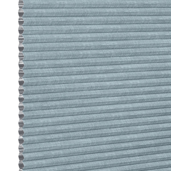 Light-blue textured cellular (honeycomb) pleated shade, tightly closed showing hexagonal cell edges at left; blocking light and insulating a window within a softly lit interior, neutral background.