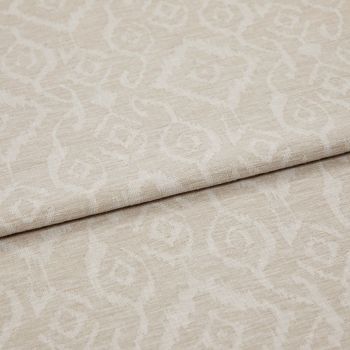 Beige jacquard fabric with subtle raised scroll-and-rose pattern, folded across the frame; overlapping layers reveal textured weave and nap under soft, neutral studio lighting in a close-up view.