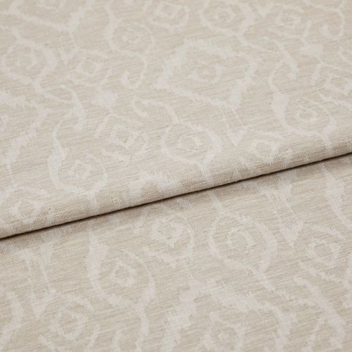 Beige jacquard fabric with subtle raised scroll-and-rose pattern, folded across the frame; overlapping layers reveal textured weave and nap under soft, neutral studio lighting in a close-up view.