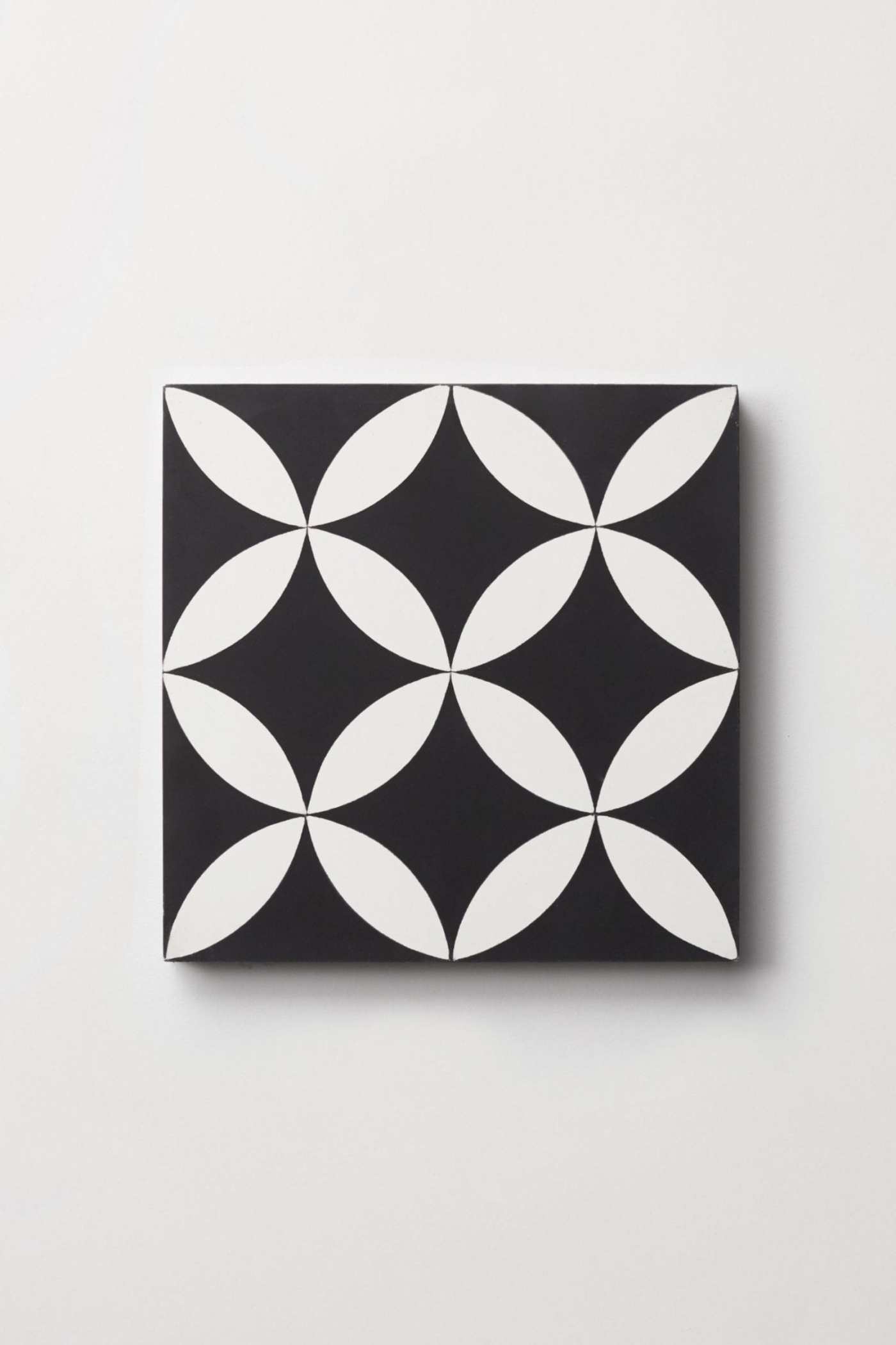 a black and white tile on a white surface.