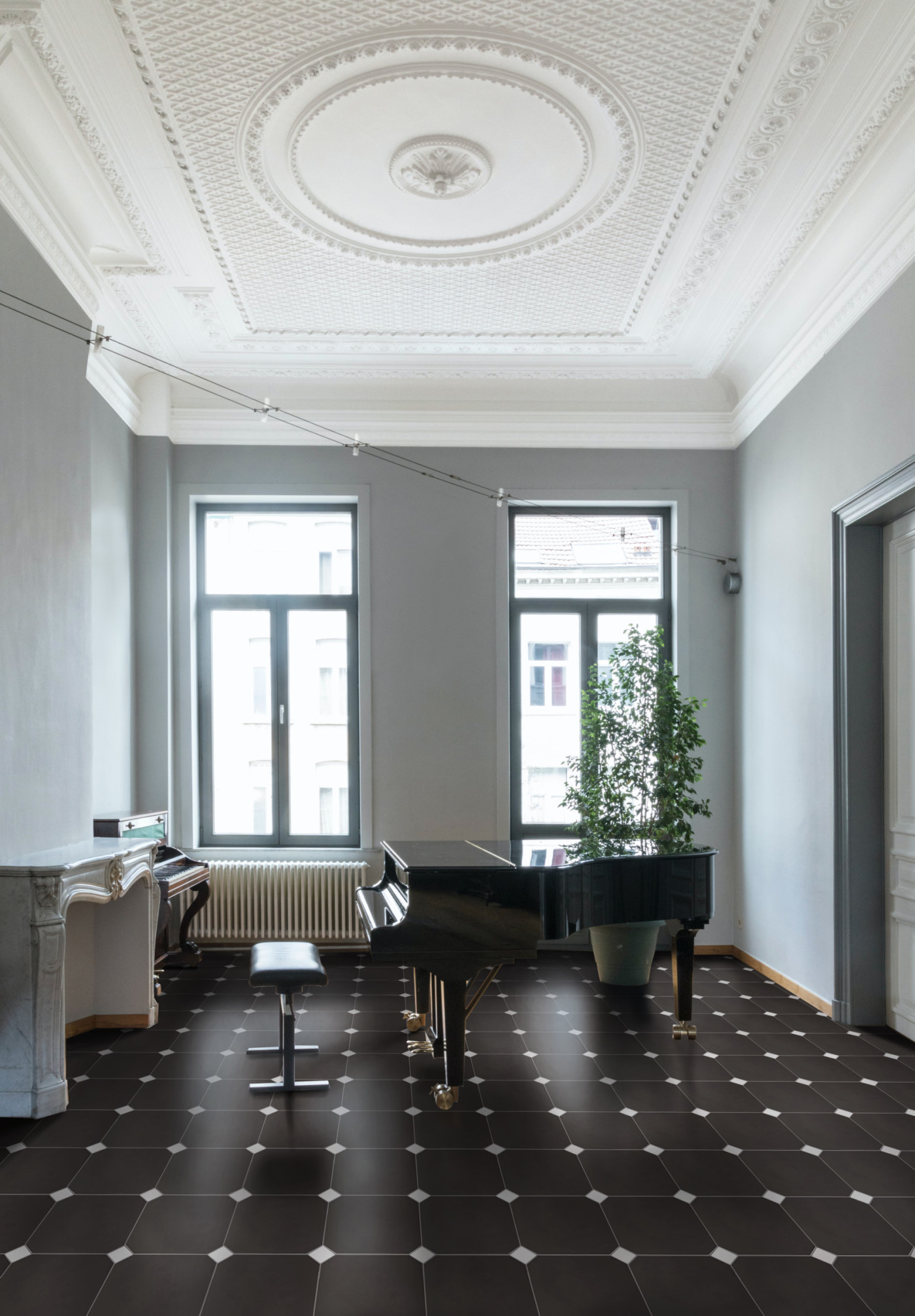 a room with a black and white tiled floor and a piano.